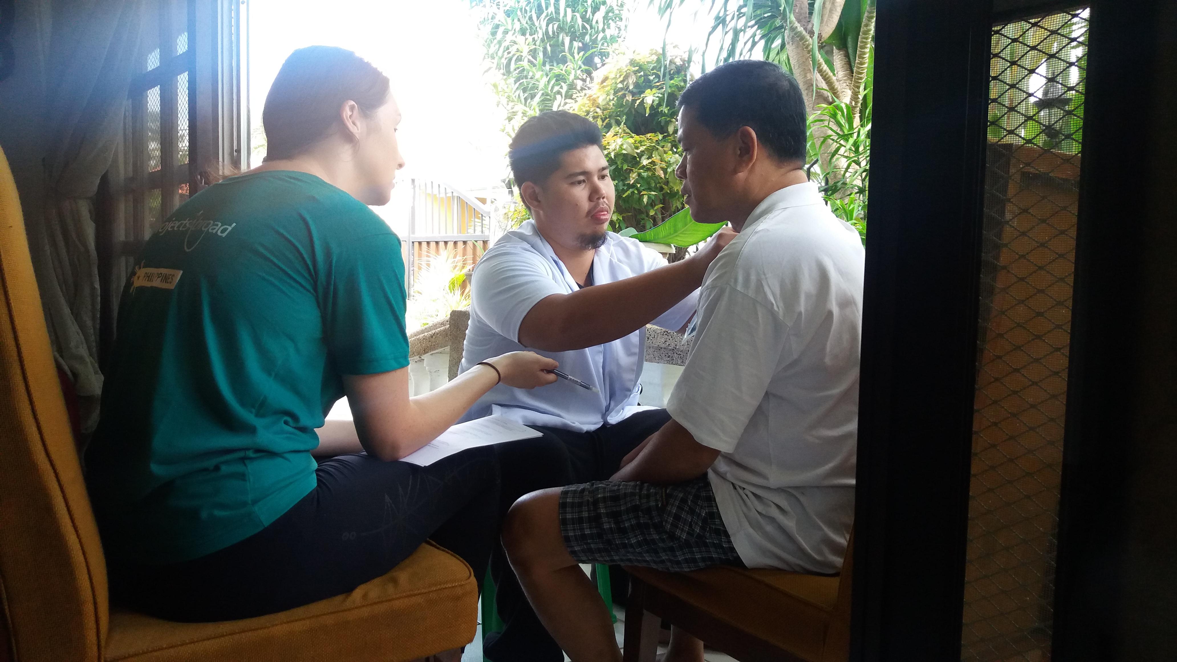 Projects Abroad interns helping a man exercise his shoulder whilst on their occupational therapy internship in the Philippines. Interns are pictured helping a man exercise his shoulder whilst they complete their occupational therapy internship in the Philippines.